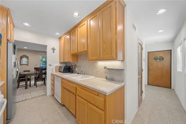 a kitchen with a sink cabinets and window