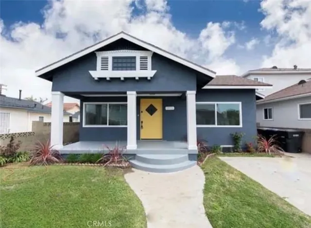 a front view of a house with a yard outdoor seating and garage