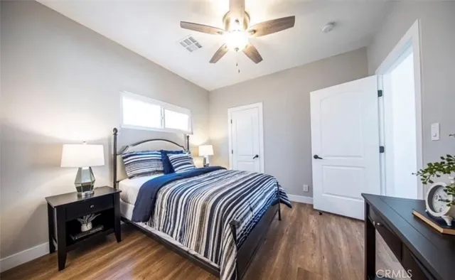 a bedroom with bed and a potted plant