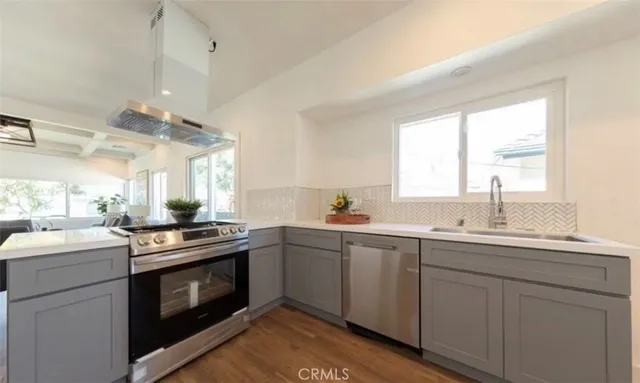a kitchen with a sink stove and cabinets
