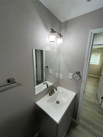 a bathroom with a sink a mirror and vanity