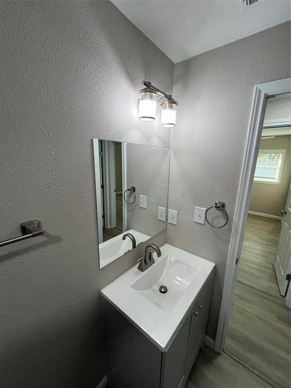 207 Wilmer Heights Drive Wilmer, TX 75172 - Photo 13 of 22 a bathroom with a sink a mirror and vanity