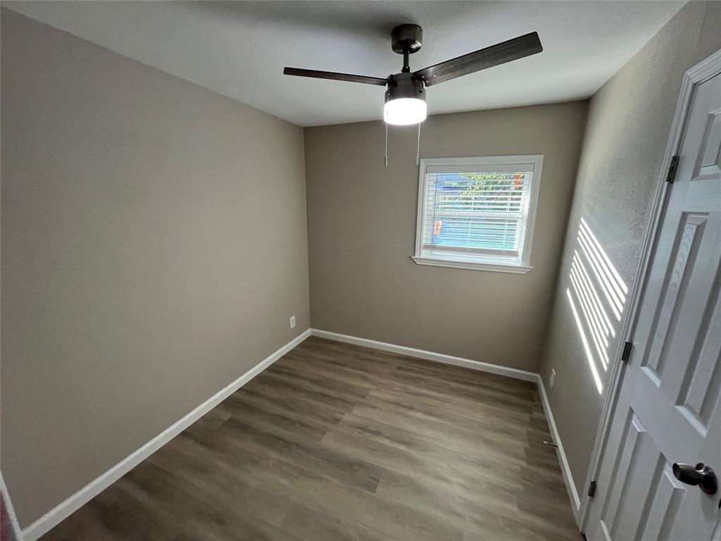 207 Wilmer Heights Drive Wilmer, TX 75172 - Photo 15 of 22 an empty room with wooden floor and windows