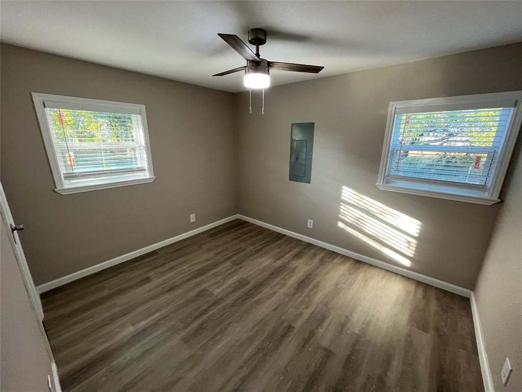 207 Wilmer Heights Drive Wilmer, TX 75172 - Photo 17 of 22 a view of an empty room with a window and wooden floor