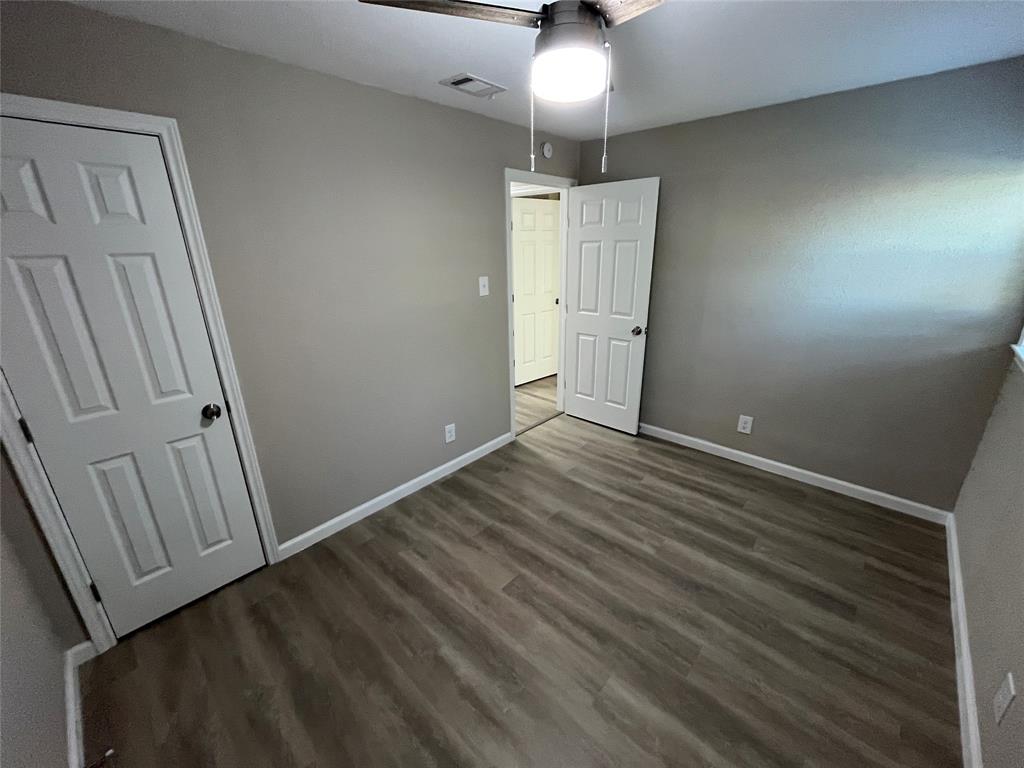 207 Wilmer Heights Drive Wilmer, TX 75172 - Photo 20 of 22 an empty room with wooden floor and entrance