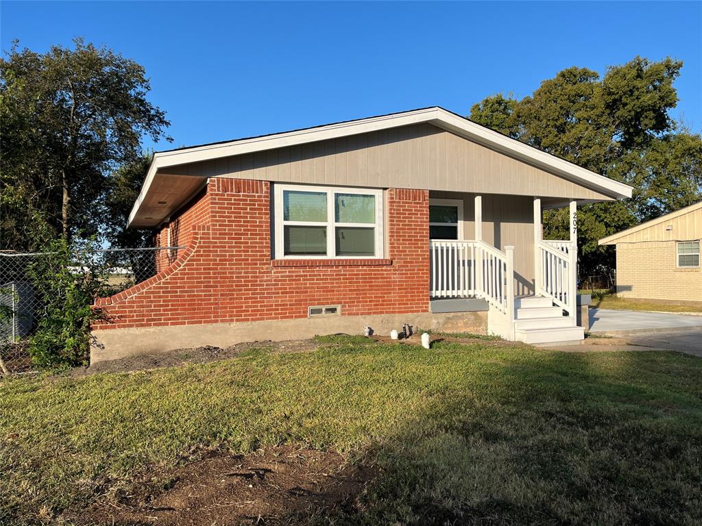 207 Wilmer Heights Drive Wilmer, TX 75172 - Photo 2 of 22 a front view of a house with a yard