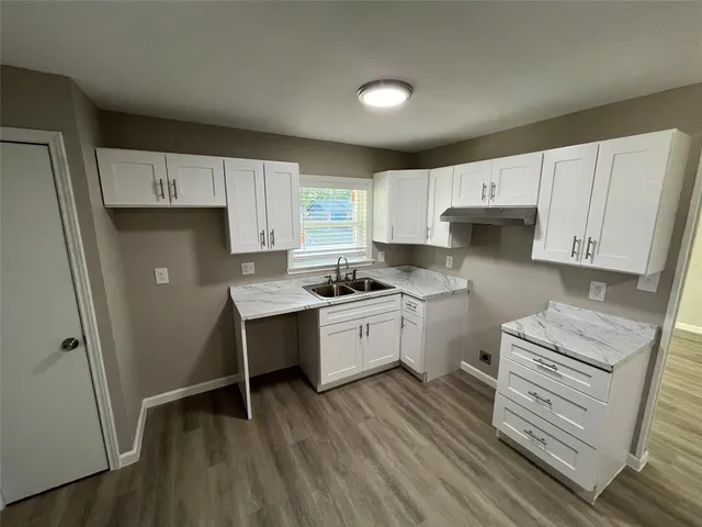 a kitchen with white cabinets and white appliances