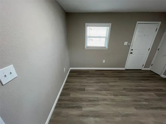 a view of room with window and wooden floor