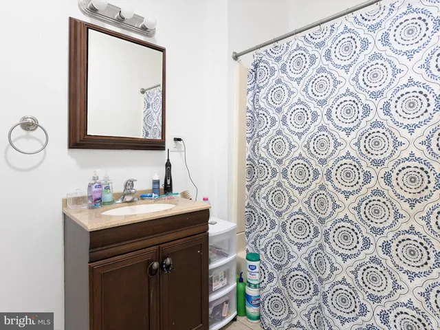 a bathroom with a sink mirror and vanity