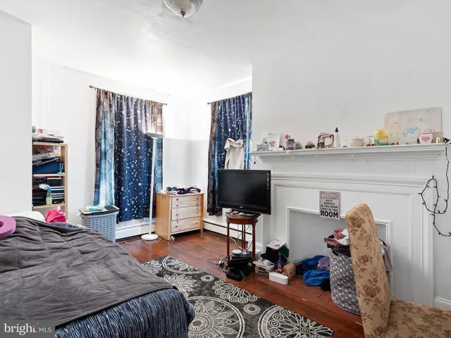 a bedroom with a bed and flat screen tv