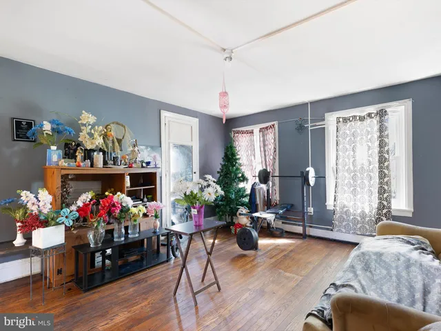 a living room with furniture and flowers