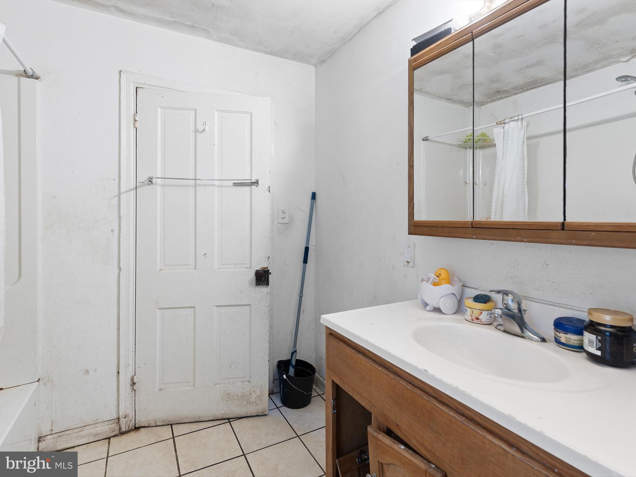 125 West State Street Kennett Square, PA 19348 - Photo 26 of 50 a bathroom with a sink and a mirror
