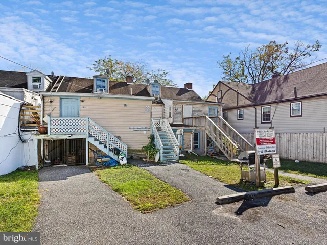an aerial view of a house with swimming pool and porch