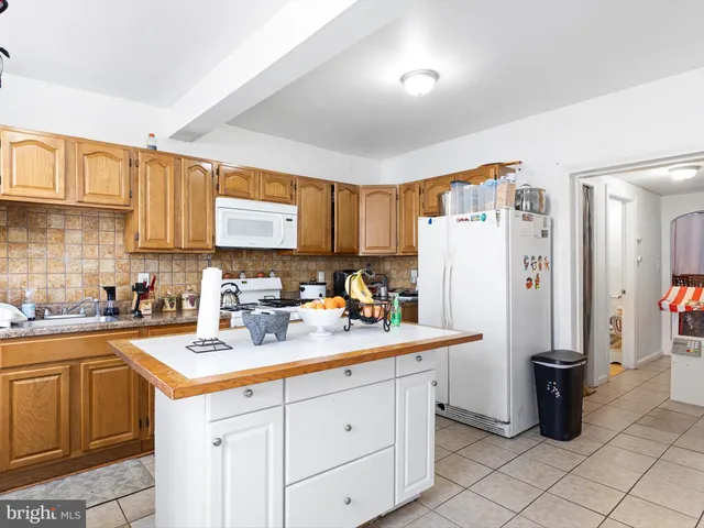 a kitchen with refrigerator and cabinets