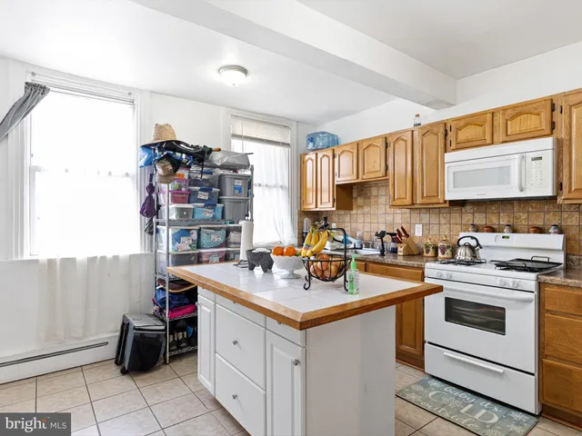a kitchen with a sink cabinets and window