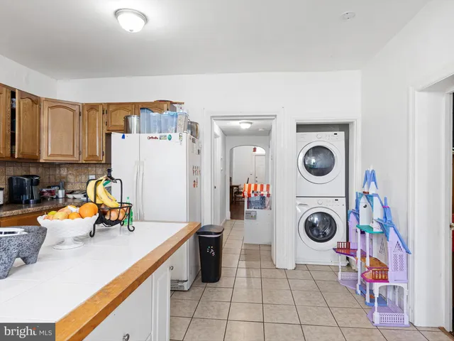 a kitchen with a sink a stove and cabinets