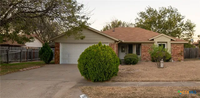 a front view of a house with a garden and plants