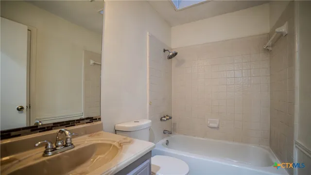 a bathroom with a sink toilet tub and shower