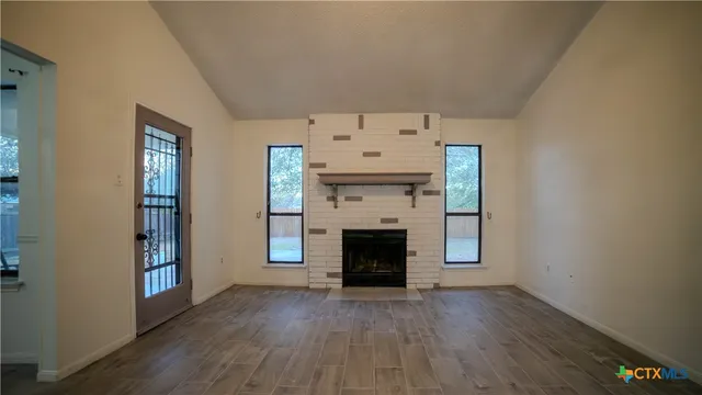 an entryway with fireplace and wooden floor