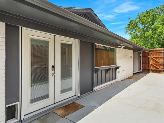 a backyard of a house with wooden floor and fence