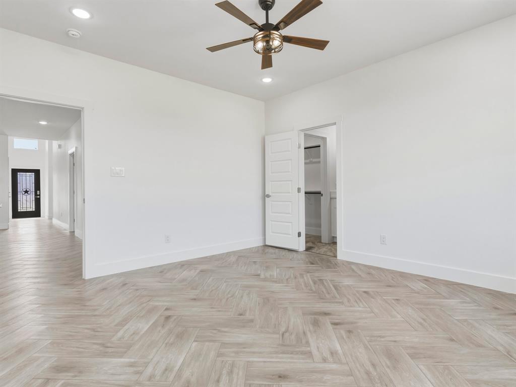 1412 Ridgeview Circle Granbury, TX 76048 - Photo 11 of 20 wooden floor in an empty room with a window