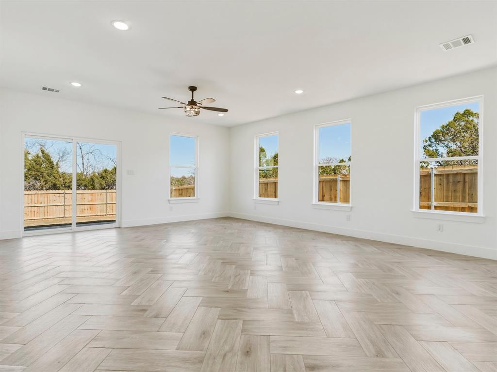 1412 Ridgeview Circle Granbury, TX 76048 - Photo 7 of 20 an empty room with windows and chandelier