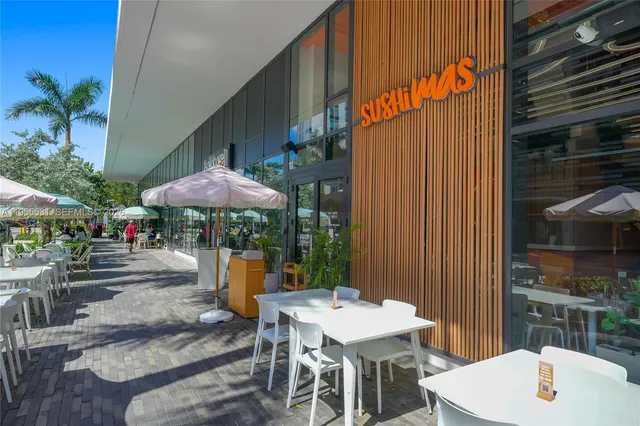 a outdoor seating space with furniture and umbrella