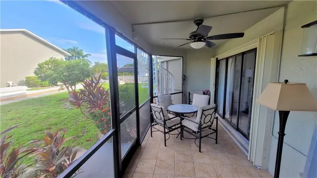a view of a porch with furniture and a yard