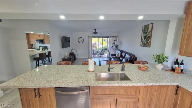 a view of a kitchen counter top space and living room