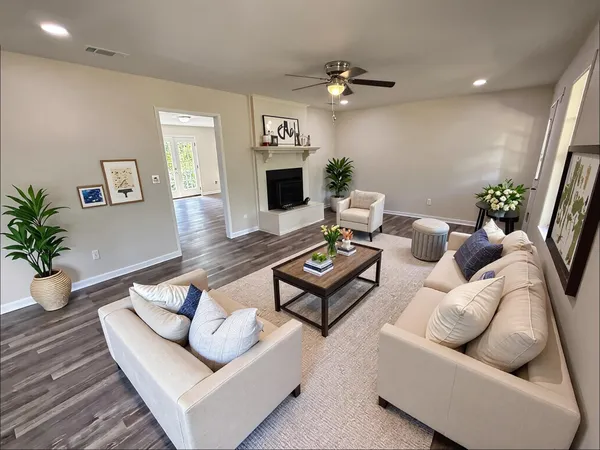 a living room with furniture and a potted plant