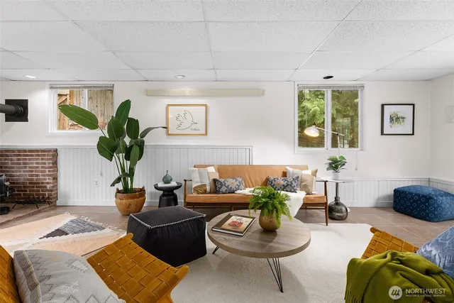 a living room with furniture and a potted plant