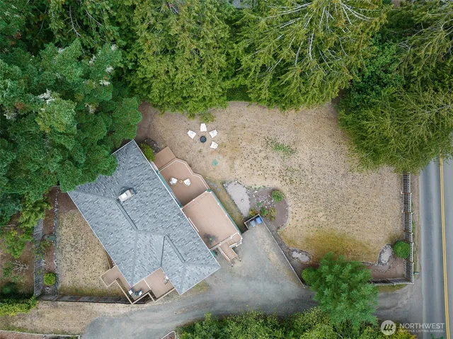 an aerial view of a house with a yard and trees