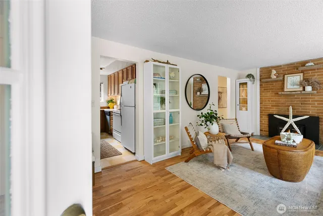 a living room with furniture a flat screen tv and a wall clock
