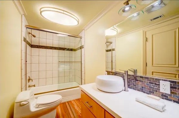 a bathroom with a tub sink and shower
