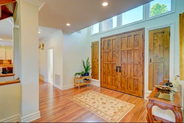 a view of a living room with furniture and wooden floor