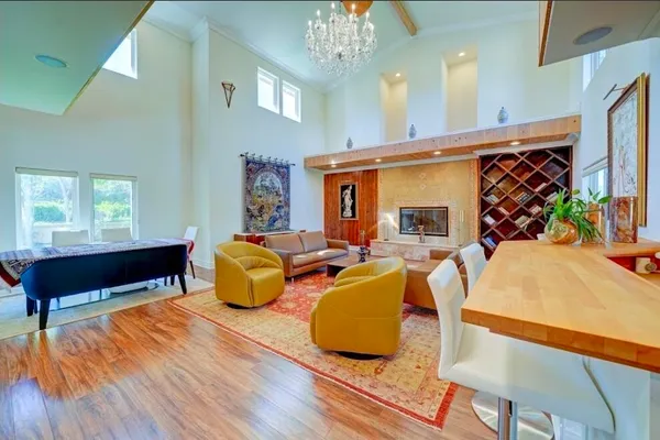 a living room with furniture wooden floor and a table