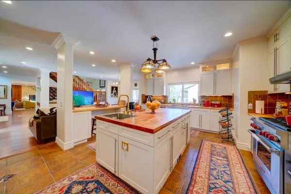 a bathroom with a granite countertop sink a bathtub and next to a window