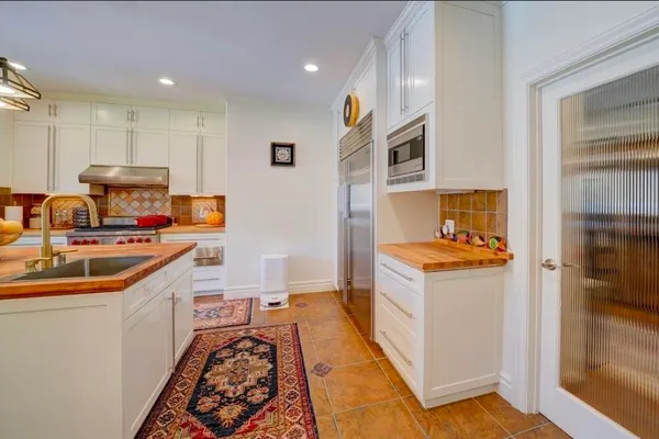 a spacious bathroom with a tub a sink and mirror