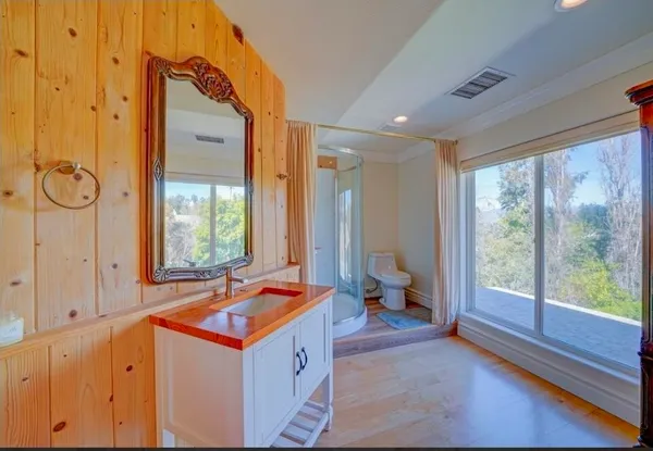 a bathroom with a sink toilet and shower
