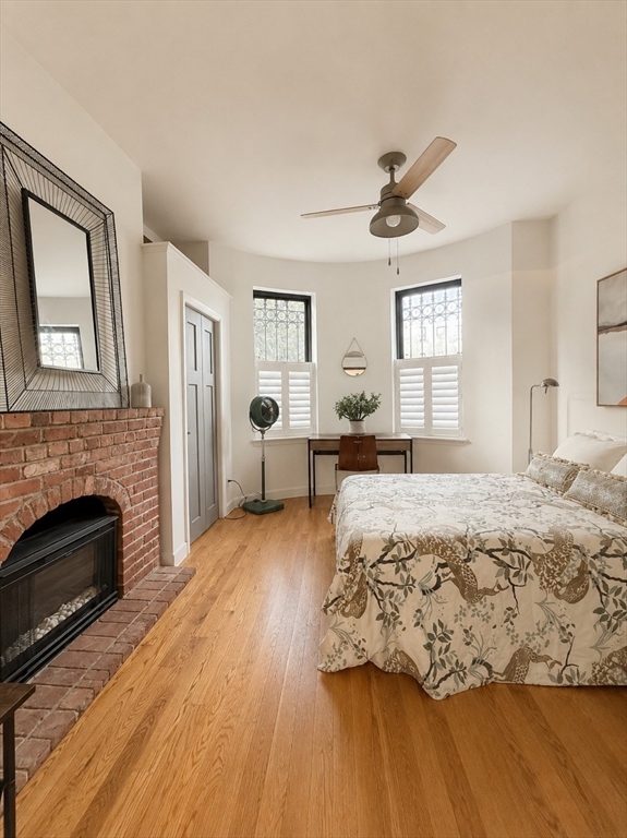 9 Albemarle Street, Unit 2 Boston, MA 02115 - Photo 2 of 11 a bedroom with a bed and a fireplace
