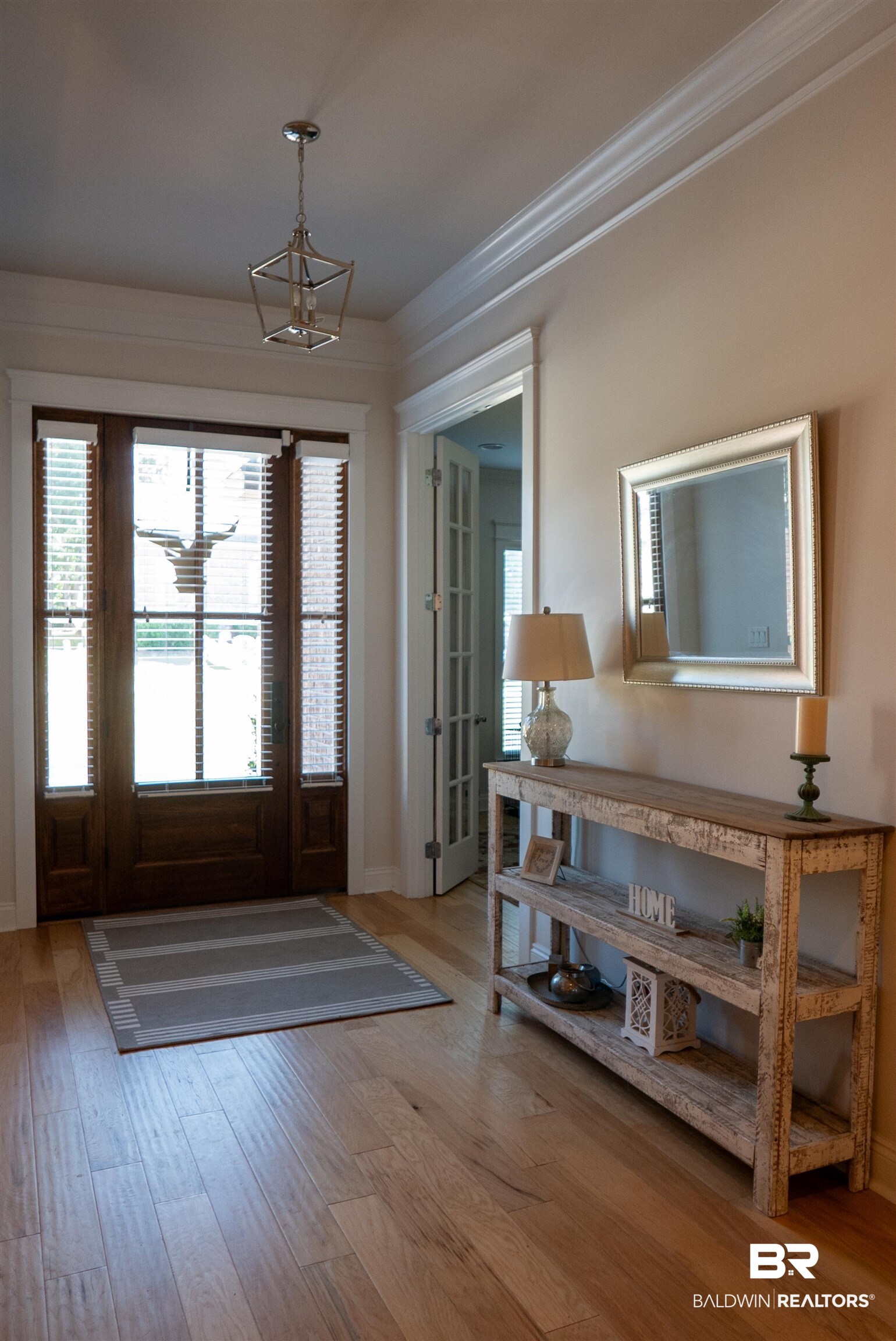 6684 Garrison Drive Daphne, AL 36527 - Photo 28 of 35 Foyer entrance featuring hardwood / wood-style floors, crown molding, and an inviting chandelier
