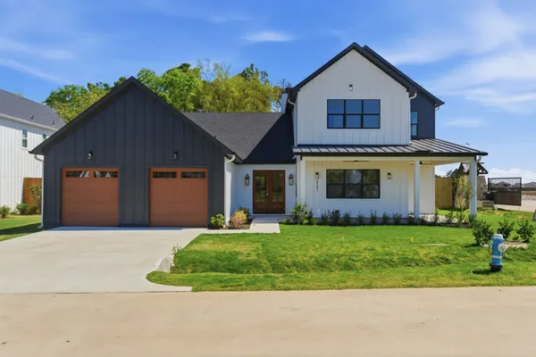 a front view of a house with a yard and garage