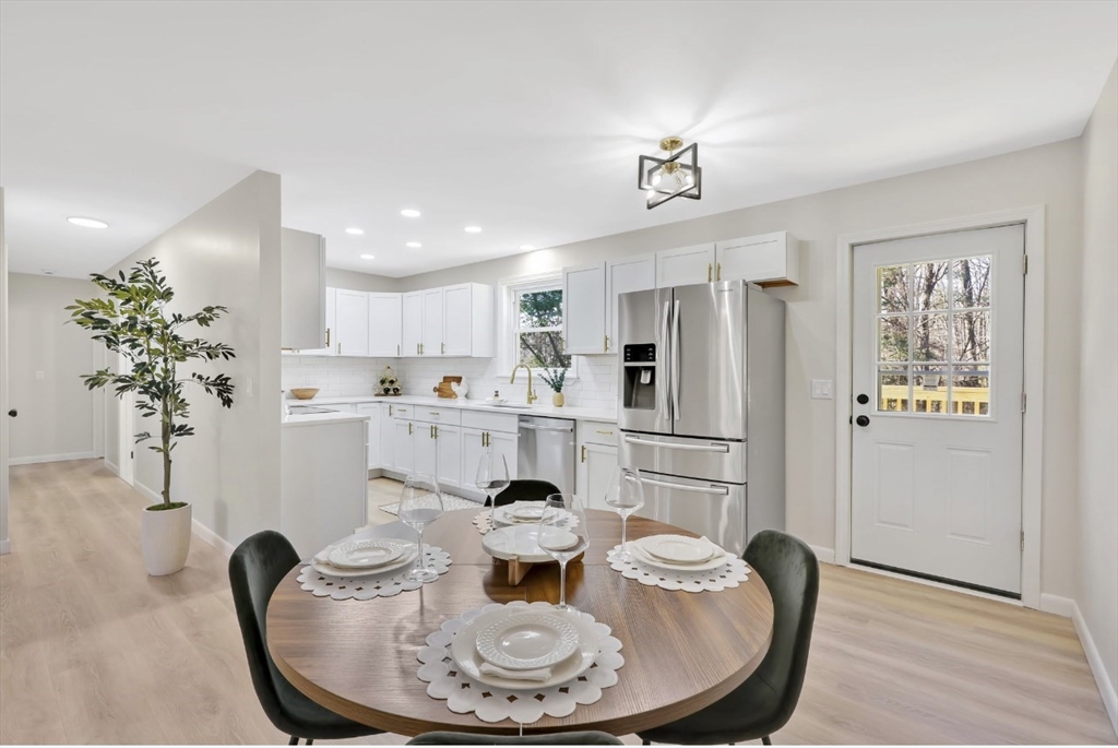 33 Brimfield Road Holland, MA 01521 - Photo 6 of 27 a kitchen with stainless steel appliances granite countertop a refrigerator a sink a stove and white cabinets