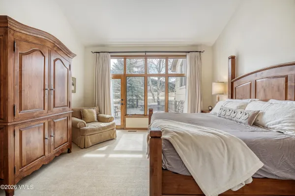 a bed sitting in a bedroom next to a window