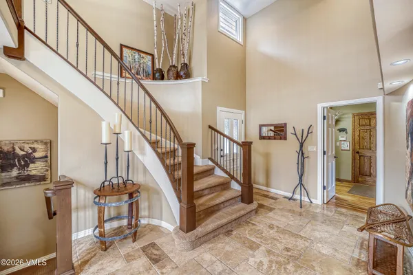 a view of entryway and hall with wooden floor