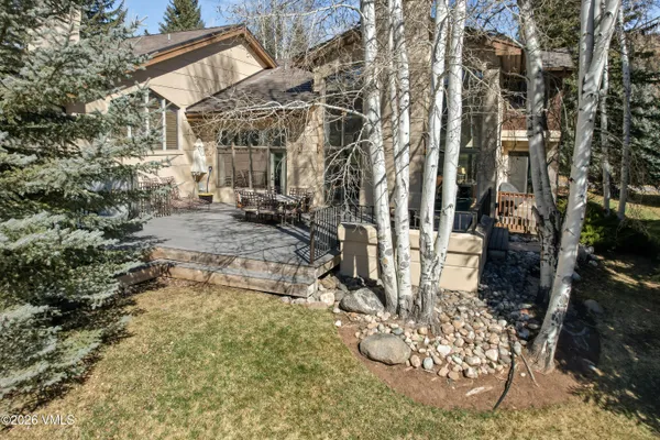 a view of a yard with table chair