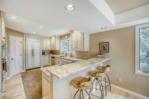 a living room with stainless steel appliances kitchen island granite countertop furniture and a kitchen view