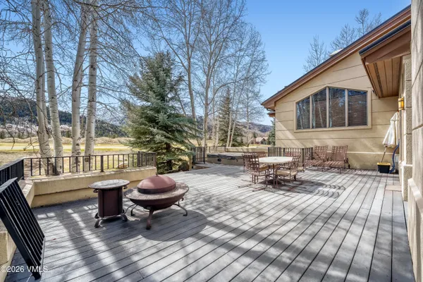 a view of a patio with a table chairs and a stove