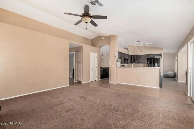 a view of a kitchen with a sink and a refrigerator