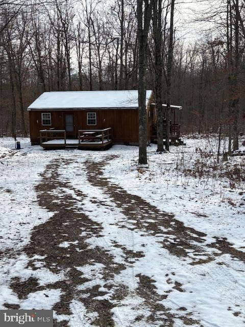 a view of a house with a yard covered in snow